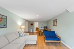 Lower level family room with sectional, game table, and workspace, ideal rainy day fun in Eastham.