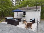 Outdoor patio lounge with string lights and fire pit, favorite spot for Eastham summer nights.