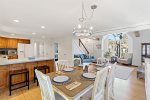 Dining table and kitchen breakfast bar, perfect for family meals and planning beach days on Cape Cod.