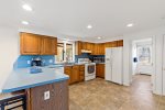 Bright kitchen with breakfast bar and full appliance setup, practical Cape Cod vacation cooking in Eastham.