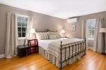 Primary bedroom with queen bed, mini split AC, and soft coastal tones, quiet retreat at Firefly Landing
