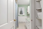 Full bathroom with tub and shower combo and generous vanity storage, clean, bright, and ready for summer rentals