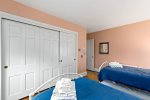 Second view of twin bedroom with closet storage, practical setup for kids, cousins, or friends on Cape Cod