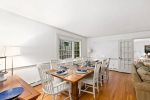 Large dining table seats a crowd for lobster nights and game nights, gather together at Firefly Landing, Cape Cod