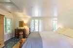 Spacious queen bedroom with soft linens and calm natural light, rest easy after beach time or exploring Cape Cod.
