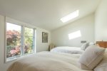 Bright guest bedroom with a skylight, great for kids, friends, or flexible sleeping in this Chatham rental.