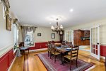 Dining room connects to the chefs kitchen, easy serving, family-style meals, and gathering space for Cape Cod vacations.