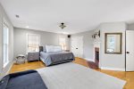 Spacious primary king bedroom with hardwood floors, private retreat for restful nights on your Cape Cod vacation.