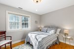 Bright guest bedroom with a double bed and sunny window, comfortable, simple space for couples or teens.