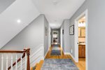 Wide upstairs hallway connects bedrooms and baths, easy flow throughout this spacious Cape Cod vacation rental.