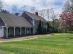Sprawling Yarmouth Port Cape Cod vacation rental with broad lawn and private drive, peaceful estate setting near Mayflower Beach.