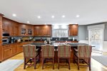 Large island in the eat-in kitchen seats four, perfect for morning coffee, quick lunches, and planning your Cape Cod day trips.