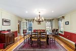 Dining room with seating for a crowd under chandelier lighting, host lobster dinners and holiday-style meals on Cape Cod.