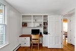 Built in workspace with shelves and desk, a convenient remote work setup for extended stays on Cape Cod.
