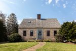 Classic Eastham exterior with cedar shingles, a welcoming front entry, and timeless Cape Cod curb appeal.