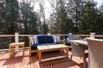 Comfortable deck lounge area adds another inviting outdoor space for morning coffee, afternoon reading, or evening cocktails.