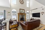 Welcome to Tres Gallos, a beautiful South Chatham vacation rental. Relax in the living room with vaulted ceilings, a smart TV, and cozy leather seating.