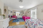 Spacious upstairs bedroom with twin beds and queen bed, bright windows, at the Tres Gallos South Chatham Cape Cod vacation rental