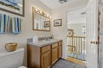 Upstairs full bath with vanity and bright mirror, convenient to both second floor bedrooms for easy mornings.