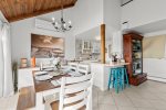 Gather around the dining table with the kitchen and breakfast bar close by for easy vacation breakfasts and casual evenings.