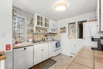 Bright, functional kitchen with dishwasher, coffee maker, and classic coastal simplicity for relaxed family stays in Wellfleet.