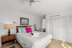 Second spacious queen bedroom with coastal decor, generous closet space, and room to settle in for a relaxing Cape Cod stay.