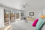Wake up to wooded and marshside views from this serene queen bedroom with direct deck access in South Wellfleet.