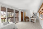 Loft level sitting and sleeping area with large sliders, natural light, and easy access to the upstairs bath.