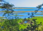 Sweeping view across Silver Spring Marsh toward Cape Cod Bay, the peaceful natural setting that defines this Wellfleet escape.