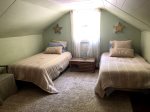 Twin beds in the second upstairs bedroom