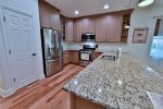 Chef-inspired kitchen features stainless steel appliances, dishwasher, disposal, refrigerator withthrough-the-door ice maker and water, natural gas stove, and coffee maker. 