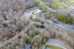 Aerial view of Clubhouse, pool, pickleball courts near house