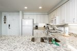Kitchen with upgraded flooring and stunning granite countertops