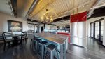 Large kitchen with spacious island and barstools for four
