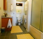 Full bathroom with washer and dryer.