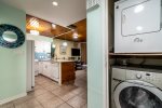 entry hallway, full size washer and dryer, blue beach wall mirror, kitchen area, dishwasher, breakfast bar, wood ceilings, tile flooring