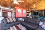 sectional sofa, coffee table, wall mirrors, wood ceiling, ceiling fan, wall art