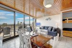 Open concept living space with wall to wall bay window for relaxing views