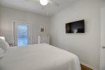 Bedroom 2 with television and shared balcony access with bedroom 3