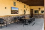 Covered patio with outdoor dining and TV