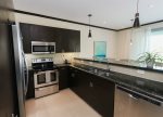 Kitchen includes appliances and cookware.