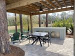 Site 7 Pull In Lake Front View with a Covered Pergola, Table & Chairs, Adironidack chairs, Cabinetry with countertop space for tabletop grill.
