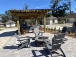 Lot 21 has a pergola, outdoor kitchen area, seating area with table and chairs and a Firepit with adirondack chairs   