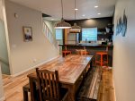 Large family-style wood dining table with two benches and two chairs. 