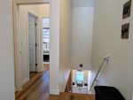 Top of the stairs going to the third floor. Entrances to the Guest and Den bedrooms are visible
