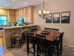 Large dining table with seating for 6 and breakfast bar with space for 3. 