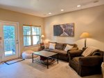 Cozy living room area with gas fireplace and looks out over peaceful forest. 