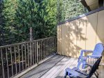 Enjoy the peaceful forest setting while lounging on the deck