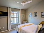 Smart TV and ceiling fan in the Guest bedroom