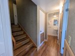 Lower hallway area and stairs going up to main floor from lowest level of the cabin